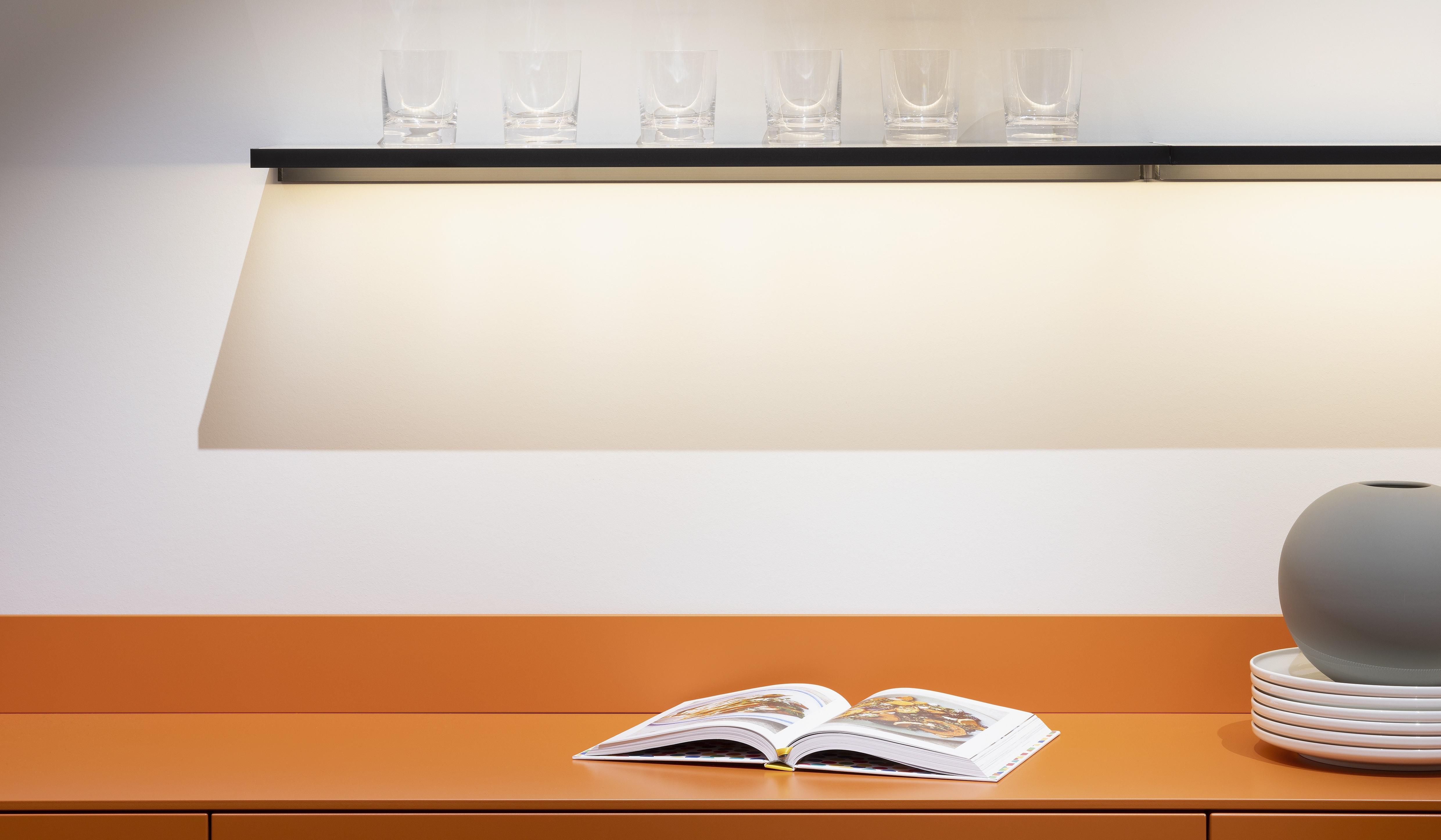 APL: 171 Greige 16 mm Front: AV 7010-GL Beton-grau, mineralischer Spachtelbeton (PUResist, PURemmision) Front Lack Orange Korpus: 2059 Designkorpus Titan Griff: Metall Black Chrome und Kehlleiste 359 Greige matt Kehlleiste Graphit gebürstet Geräte: Gaggenau Armatur: Franke Spüle: Franke  Features: Betonoberfläche individuell nachbearbeitet, Nischenrückwand Regal Betonoberfläche, Sideboard Orange mit offenen Schubkästen in Plexiglas Orange exklusives Auszugssystem im Schrank für mehr Stauraum, Sideboard 